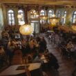 Crowded restaurant full of diners at tables