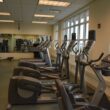 Empty gym with rows of cardio machines