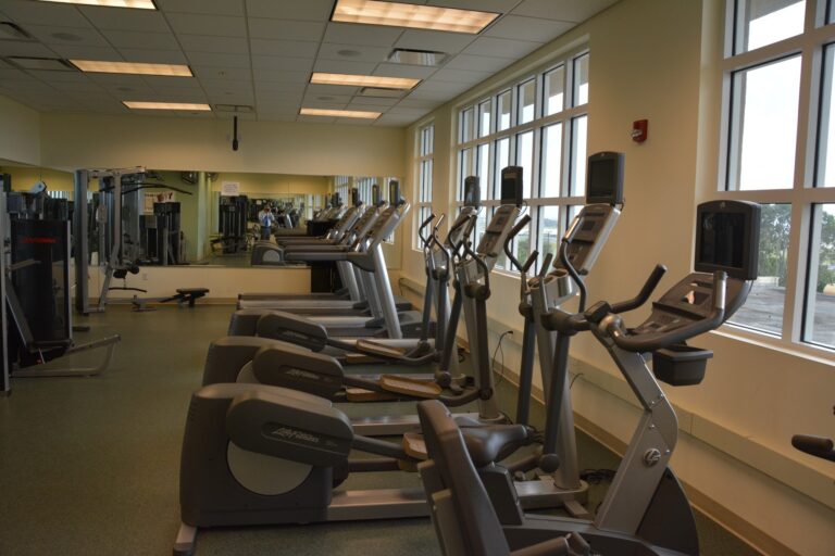 Empty gym with rows of cardio machines