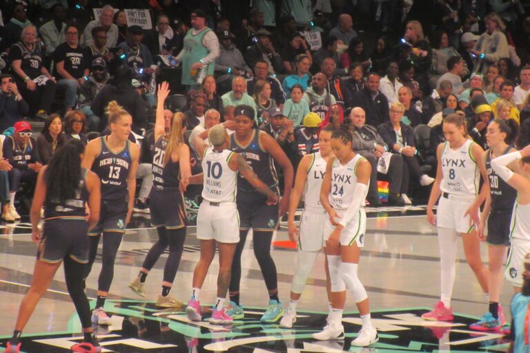 Basketball players on the court during Game 1 of the 2024 WNBA Finals between the New York Liberty and Minnesota Lynx at Barclays Center.
