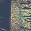 Lines of programming code displayed on a dark computer monitor.